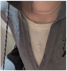 Close-up of S925 sterling silver layered necklace set with organic flow pendant on a model