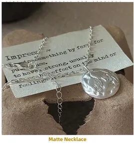 Detailed macro shot of a matte silver S925 sterling silver necklace with lunar texture