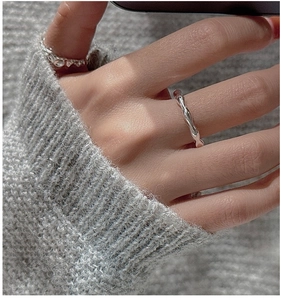 Close-up of S925 sterling silver wavy ring featuring minimalist irregular texture design