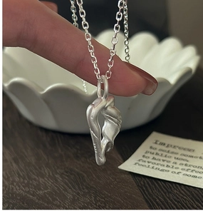 Macro detail of S925 sterling silver necklace with matte twisted pendant and hallmark