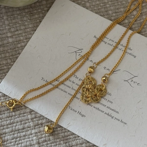Vintage S925 gold necklace featuring stacked coin charms and a heart pendant detail