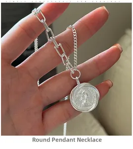 Detailed close-up of S925 sterling silver coin necklace with asymmetrical paperclip chain