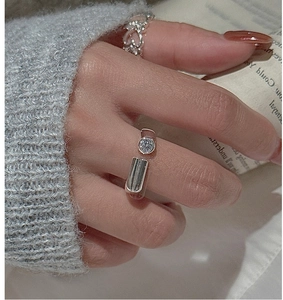 Detail of minimalist S925 silver ring featuring round zircon and rectangular metal plate