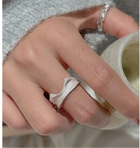 Detailed view of S925 sterling silver matte cat ear ring on model with aesthetic background