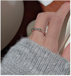 Detailed view of an S925 sterling silver ring with an irregular textured wave design