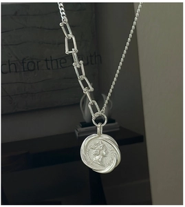 Detail of S925 silver necklace with retro portrait coin and mixed horseshoe chain links