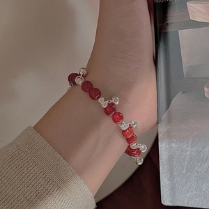 Minimalist S925 silver beaded bracelet with red agate beads worn by a model in lifestyle shot