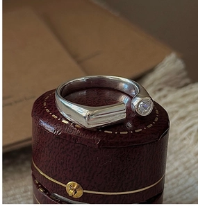 Macro shot of S925 sterling silver geometric open ring with zircon on a vintage box