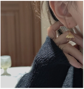 Detailed view of S925 sterling silver umbrella drop earrings worn by a female model