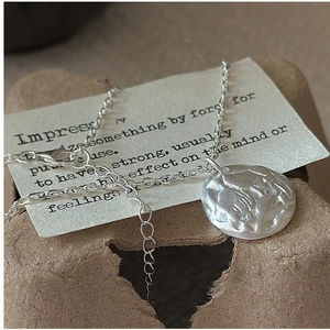 Macro detail of S925 sterling silver irregular pendant with matte texture and zircon