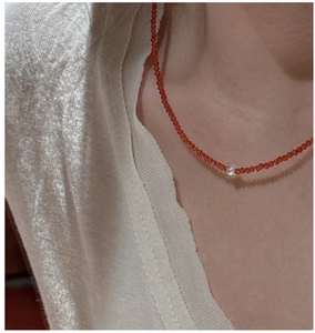 Close-up of S925 sterling silver red spinel beaded necklace worn on a female neck