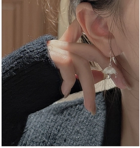 Macro shot of S925 sterling silver umbrella earrings featuring shimmering textured finish