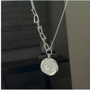 Macro view of S925 sterling silver necklace with retro coin pendant and industrial U-link chain