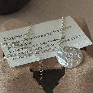 Minimalist S925 silver necklace with textured lava pendant and small cubic zirconia stones