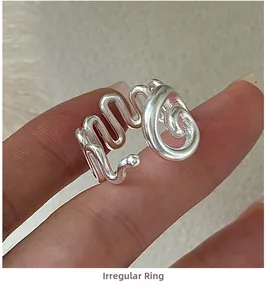 Close-up of S925 sterling silver irregular spiral ring with matte metallic texture