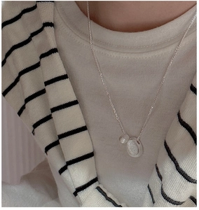 Close-up of S925 sterling silver necklace featuring two brushed texture pendant discs