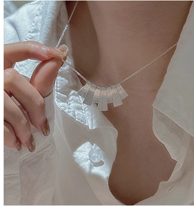 Detail of S925 sterling silver necklace with five brushed rectangular plates on a cable chain