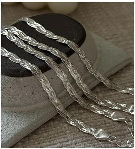 Macro detail of S925 sterling silver woven chain with ITALY 925 clasp and extender