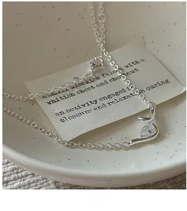Detailed close-up of S925 sterling silver knot necklace with a teardrop zircon pendant