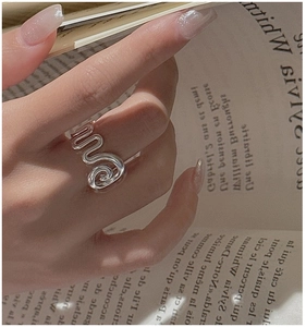 Detailed close-up of a minimalist S925 sterling silver spiral ring with vintage texture