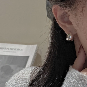 S925 sterling silver drop earrings with textured hammered finish on a female model