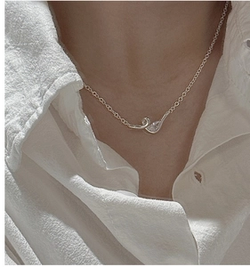 Detail view of S925 sterling silver necklace with a teardrop zircon pendant on a model