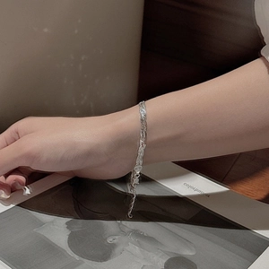 Braided S925 sterling silver chain bracelet with lobster clasp on a female wrist
