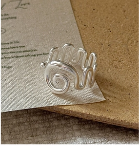 Macro shot of S925 sterling silver ring with unique spiral texture and wave design