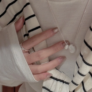 Minimalist S925 silver necklace with textured oval pendant and simple ring set on model
