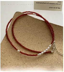 Detailed shot of red spinel beaded necklace with freshwater pearls and silver clasp