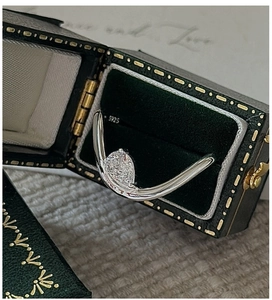 Detailed macro of S925 sterling silver stamp on a minimalist pear-cut gemstone ring