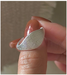 Macro detail of the matte brushed texture on a S925 sterling silver minimalist ring