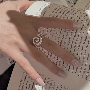 S925 sterling silver spiral ring with textured swirl design worn during reading