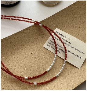 Macro detail of S925 silver necklace with red spinel beads and natural pearls