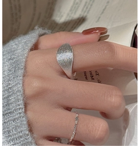 Macro shot of S925 sterling silver ring set featuring brushed matte and twisted rope textures