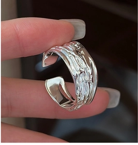 Detailed view of S925 sterling silver ring with irregular molten lava texture on finger