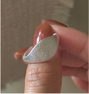 Macro shot of minimalist S925 sterling silver ring with brushed matte textured finish