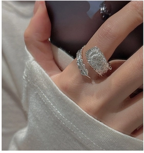 Detailed view of adjustable S925 silver feather ring with sparkling zircon stones