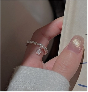 Detail of S925 sterling silver beaded ring featuring a delicate five-petal flower pendant