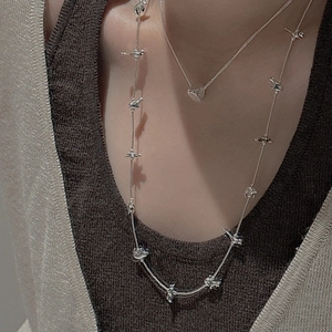 S925 sterling silver animal world sweater necklaces layered on a knit sweater