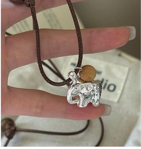 Detailed macro view of S925 silver elephant pendant with ornate engraved floral patterns