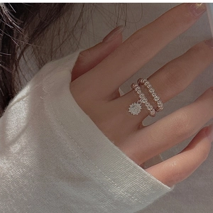 Detail of S925 sterling silver beaded double ring with a sun pendant on finger