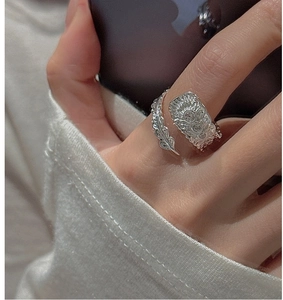 Detail of vintage sterling silver feather ring with zircon stone and retro engraving