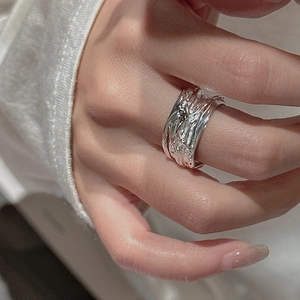 S925 sterling silver wide ring with irregular vintage lava texture on a model's finger