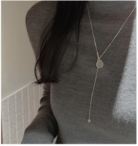 Detailed view of S925 silver tennis racket pendant on a Y-shaped long necklace chain
