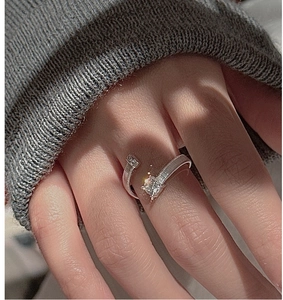 Detail of S925 silver ring featuring a large square clear gemstone and textured band