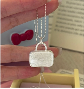 Detailed view of S925 sterling silver handbag pendant with vintage brushed texture finish