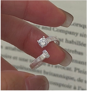 Macro detail of S925 sterling silver ring with hand-wound texture and zircon stone