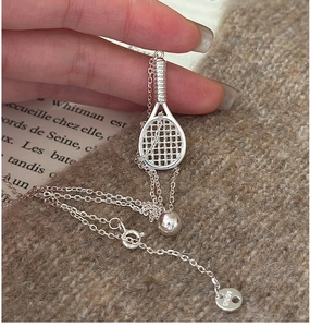 Macro shot of S925 sterling silver tennis racket necklace with AG925 hallmark tag