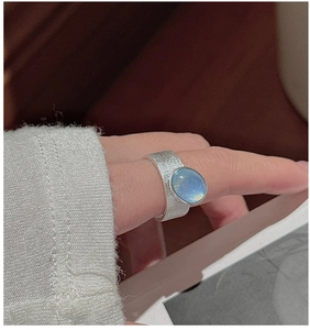 Detailed view of wide S925 sterling silver ring featuring a blue oval gemstone and matte texture